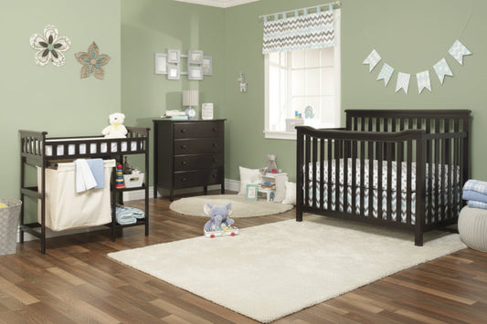 Nursery room with black crib, changing table, and dresser.