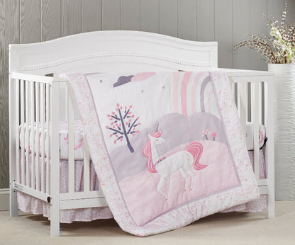 White crib with pink unicorn-themed bedding in a nursery setting