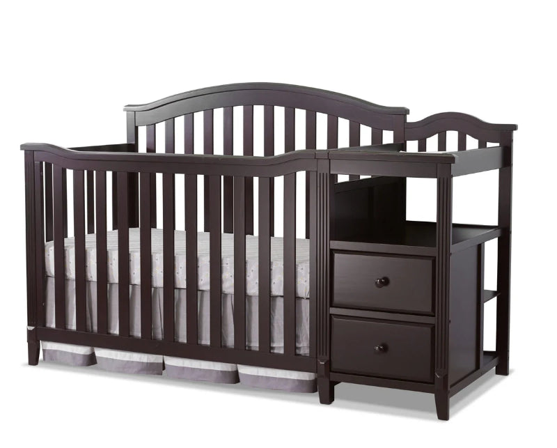 Dark wood crib with changing table on a white background