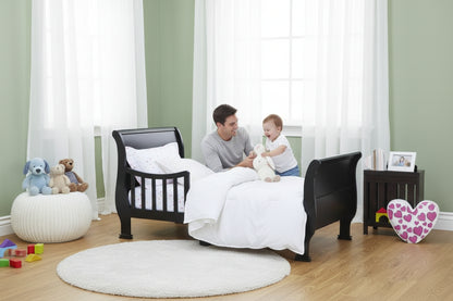Black toddler bed in a child's bedroom with decorative elements.