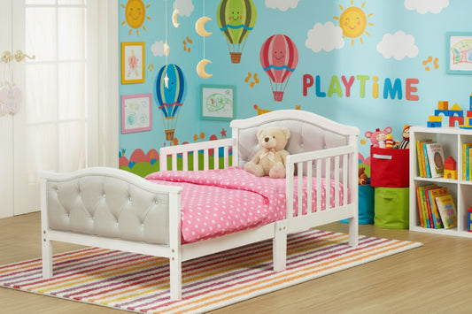 White children's bed with tufted headboard in a room with purple walls and a window.