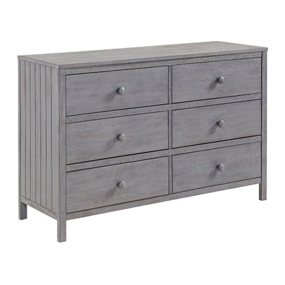 A gray wooden six-drawer dresser with round metal knobs, shown from a three-quarter angle on a white background.