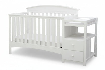 Gray crib with changing table on a white background