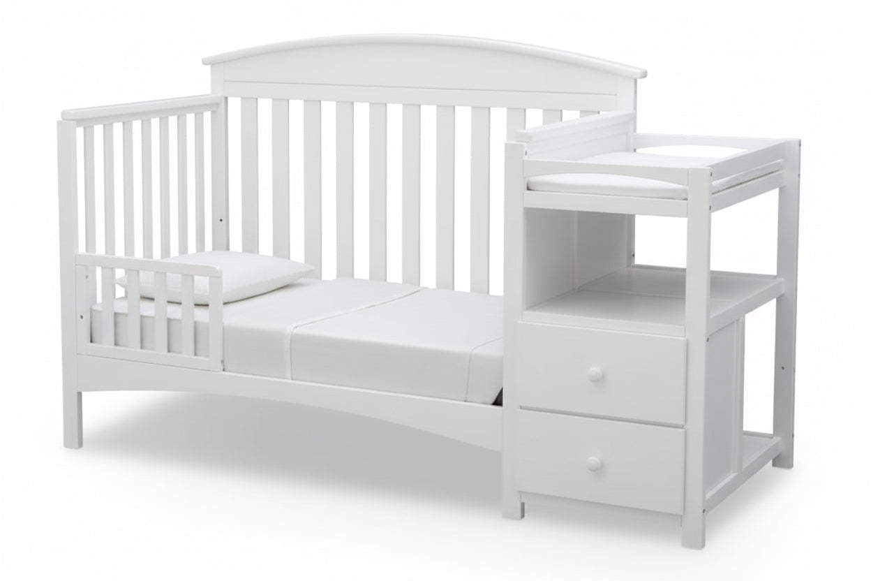 Gray crib with attached changing table on a white background