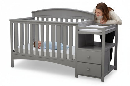 Gray crib with changing table on a white background