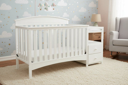 Gray crib with changing table on a white background