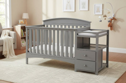 Gray crib with changing table in a nursery setting