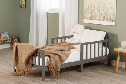 Children's bedroom with a gray bed, brown blanket, and white pillows.
