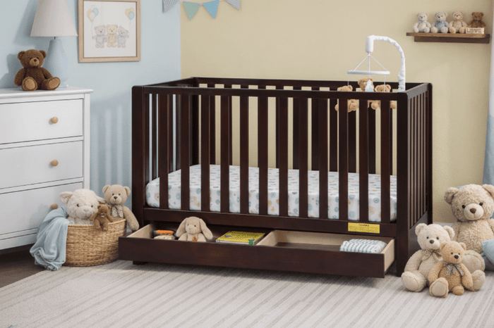 Wooden crib with toys and bedding in a nursery setting