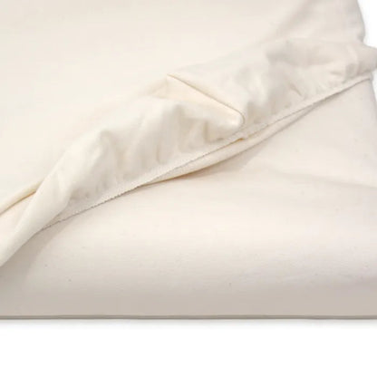 Close-up of beige fabric with a subtle pattern on a white background