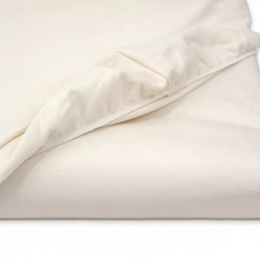 Close-up of beige fabric with a subtle pattern on a white background