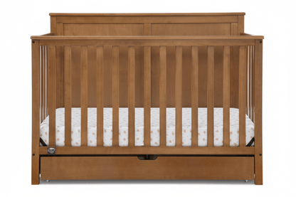 Wooden crib with a white mattress on a white background