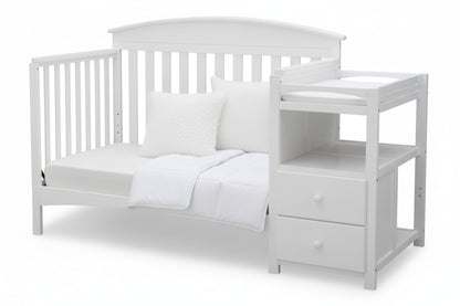 Gray crib with a changing table on a white background