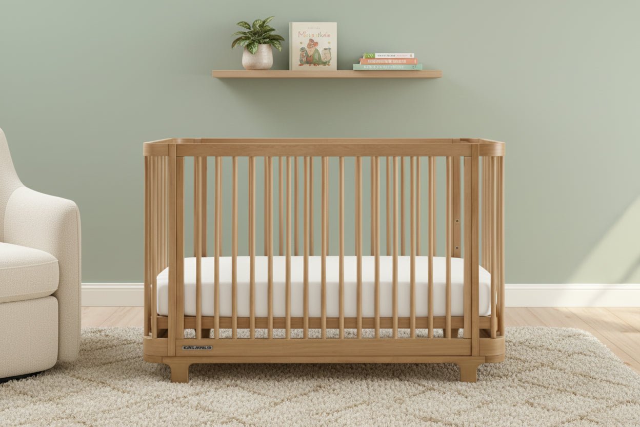 Wooden crib with a white mattress on a plain background