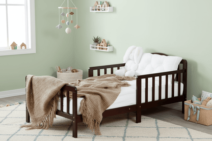 Wooden crib with blankets in a room setting