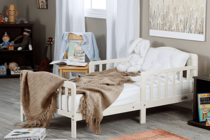 Wooden crib with blankets in a room setting