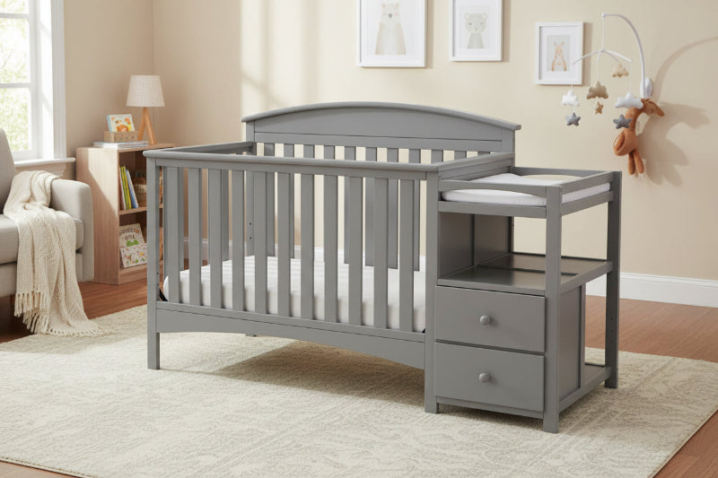 Gray crib with changing table in a nursery setting