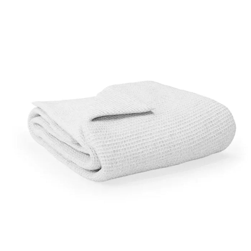 Folded white blanket on a white background