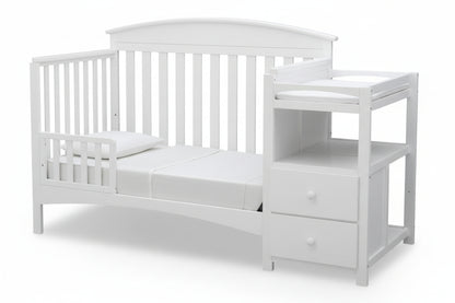 Gray crib with attached changing table on a white background